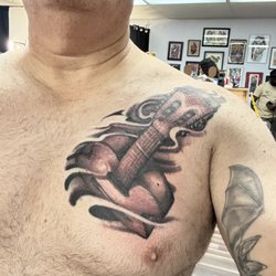 Against The Grain - Guitar tattoo by Cody Gower