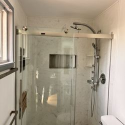 Ace Works - Solid surface walls, fold down seat, 2-nitches, shower tower with rain head, body sprays and hand held spray wand, beautiful bypass doors.