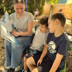 Sunshine House Preschool - Storytelling in nature! Outdoor reading sessions promote early literacy, language skills, and shared discovery.