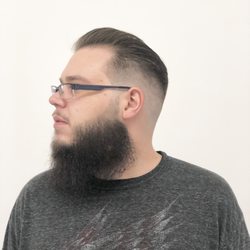 Hometown Barbershop - Pompadour styled hair cut with a skin fade on the side. Freehand clipper cutting to even out the beard and a straight razor line up.