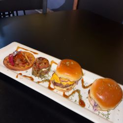 Platform Dining & Lounge - Sweet potato waffle with hot honey, fish & burger slider, salmon nugget on fried quinoa--Southern soul Land Air & Sea Sampler