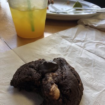 Tumerico - Delicious cocoa cookie with Turmeric bev and cleaned dinner plate in the back - Vegan Near Me - Tucson, Arizona