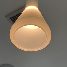 Dusty light fixtures hanging above the table