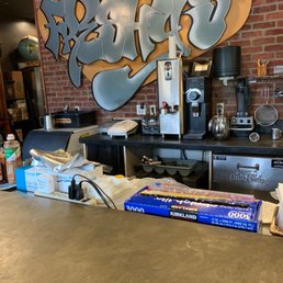 a counter with a box of pizza a counter with a box of pizza