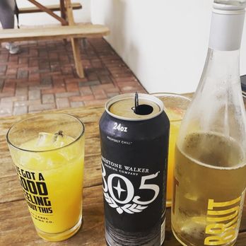The Gremlin - a can of soda and a glass of orange juice - Beer Gardens Near Me - McAllen, Texas