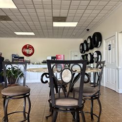 Pete Smith Tire & Quick Lube - Tables in the waiting area with tires on the wall