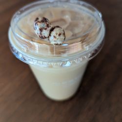 The Human Bean - Coffee beans on top of drink at The Human Bean.