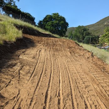 Greenlee Skid Steer - Road freshly cut to provide access to the top of a hill - Landscaping Near Me