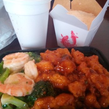 Rose Garden - Dragon and Phoenix (comes with rice) and soda - A Chinese takeout meal includes shrimp with broccoli, chicken in sauce, rice in a box, a soda, and a white cup with a lid. - Fast Food Near Me - Albuquerque, New Mexico