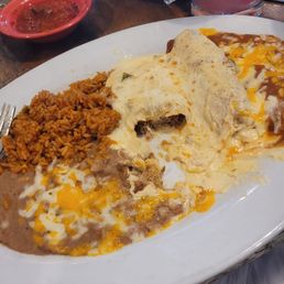 Cheese enchilada with red sauce, sweet pork enchilada and chile relleno with creamy queso, beans and rice Cheese enchilada with red sauce, sweet pork enchilada and chile relleno with creamy queso, beans and rice