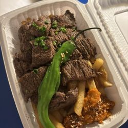 Steak plate with fries and shishito pepper