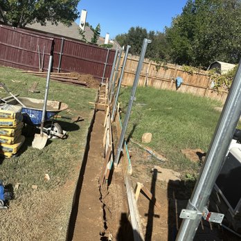 Ntx Exterior Services - Work in progress to add a concrete retaining wall under the fence - Fences & Gates Near Me