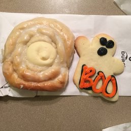 a cinnamon roll and a decorated cookie a cinnamon roll and a decorated cookie