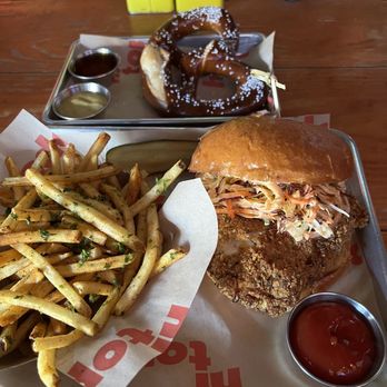 Hi Tops - Fried Chicken Sandwich with Garlic Truffle Fries and a pretzel. - Gay Bars Near Me - West Hollywood, California