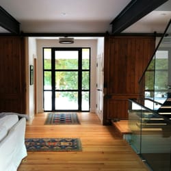 New Bern Home Improvements - Glass & iron front door with sliding barn doors in Water Mill, NY - Dennis Schorndorf Fine Homebuilding