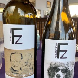 two bottles of wine on a table two bottles of wine on a table