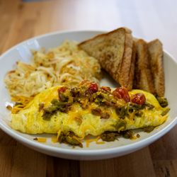 The Ivory Brunch House - New Mexico Omelet - Inspired by local flavors, this omelet features roasted Hatch green chili, melted cheddar, fresh tomatoes, and onions