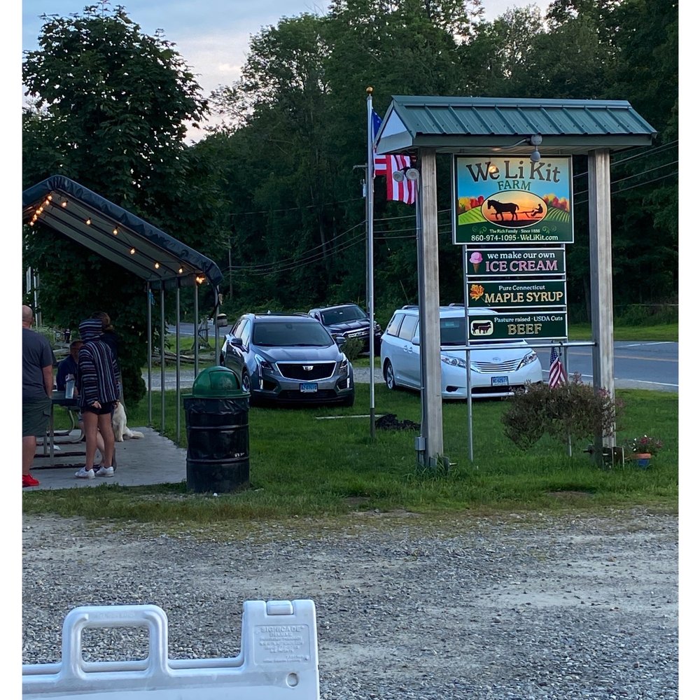 We-Li-Kit Ice Cream - ows a man and a woman standing in front of a sign - Ice Cream & Frozen Yogurt Near Me - Pomfret Center, Connecticut We-Li-Kit Ice Cream - ows a man and a woman standing in front of a sign - Ice Cream & Frozen Yogurt Near Me - Pomfret Center, Connecticut