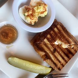 Pimento cheese grilled cheese with bacon and chutney and a pickle with a side deviled eggs . Pimento cheese grilled cheese with bacon and chutney and a pickle with a side deviled eggs .