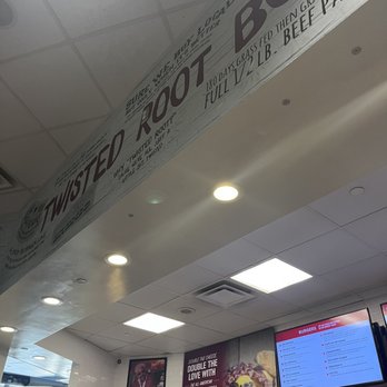 Twisted Root - a sign in a restaurant - Burgers Near Me - Dallas, Texas