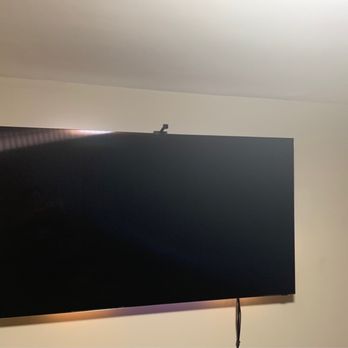 NYC Professional TV Installation - 75 inch TV that Christian mounted in my living room. He offered to also hide the cables however I chose not too. Still looks great! - Home Theatre Installation Near Me
