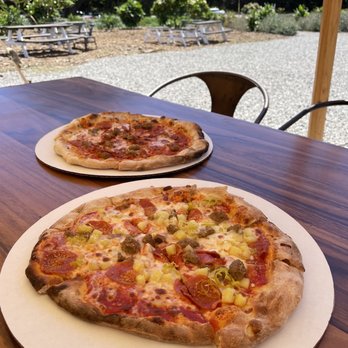 Kamala's Kitchen - Kamala's Special in front and meat lovers in back! - Pizza Near Me