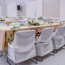 Friendship Auditorium - Tables and chairs provided. You need to provide table cloths and chair covers.