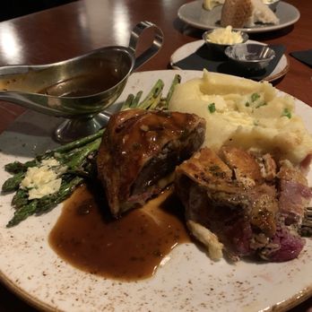 Jak's Grill - Medium rare beef Wellington cut in half with Demi sauce, grilled asparagus with garlic mashed potatoes - Steakhouses Near Me - Issaquah, Washington Jak's Grill - Medium rare beef Wellington cut in half with Demi sauce, grilled asparagus with garlic mashed potatoes - Steakhouses Near Me - Issaquah, Washington