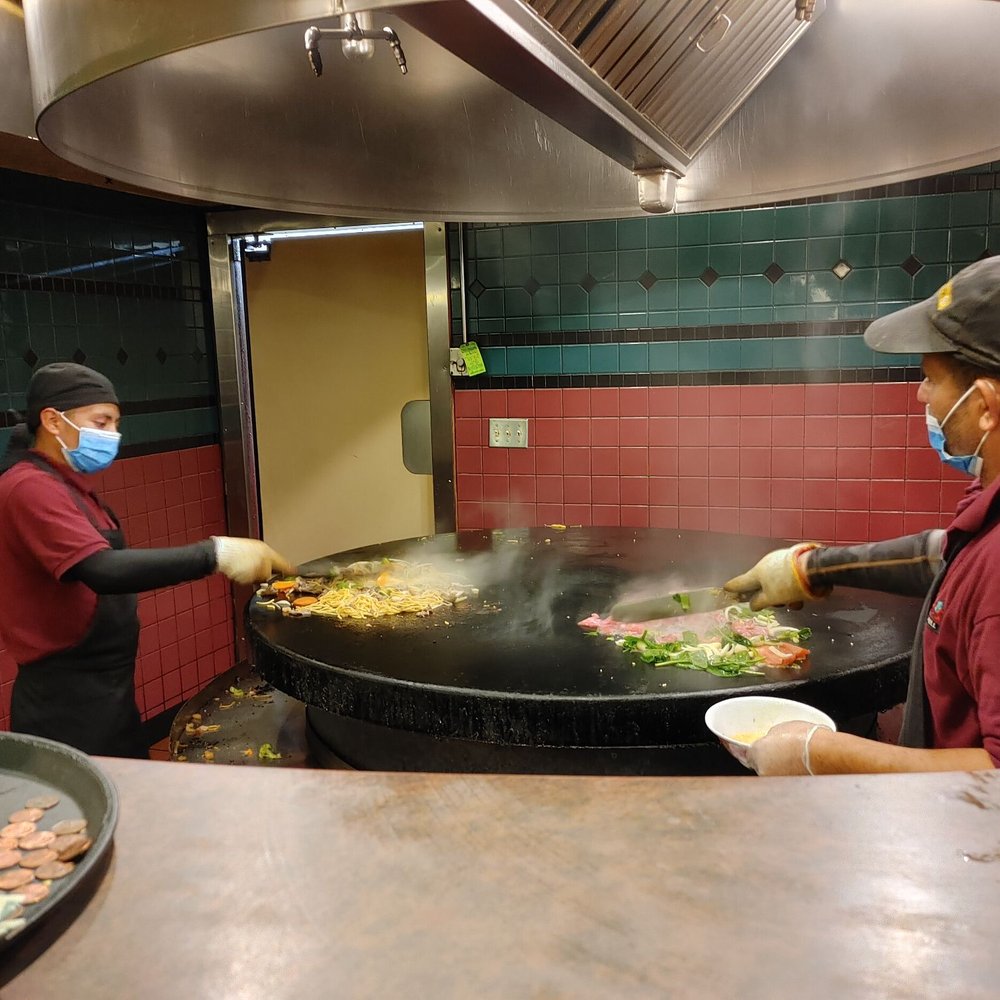 Chang's Mongolian Grill - a man in a mask cooking food - Mongolian Near Me - Portland, Oregon Chang's Mongolian Grill - a man in a mask cooking food - Mongolian Near Me - Portland, Oregon
