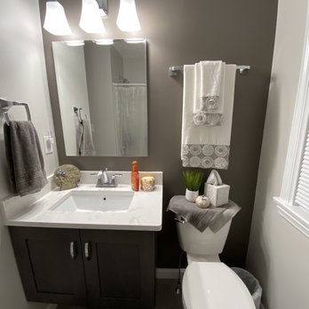 Duncan Kitchen & Bath - a bathroom with a toilet, sink, and mirror - General Contractors Near Me - Hanson, Massachusetts