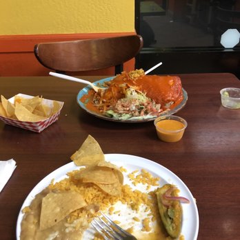 Taqueria La Perla - Rice and beans plate, with wet burrito in the background - Mexican Near Me - Pacifica, California Taqueria La Perla - Rice and beans plate, with wet burrito in the background - Mexican Near Me - Pacifica, California