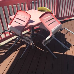 a table and chairs on a deck a table and chairs on a deck