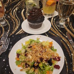 Cracked Pepper Catering & Bakery - Harvest salad with spring greens, romaine, beets, roasted sweet potatoes and sprinkle of granola. Jumbo double chocolate cupcake in back