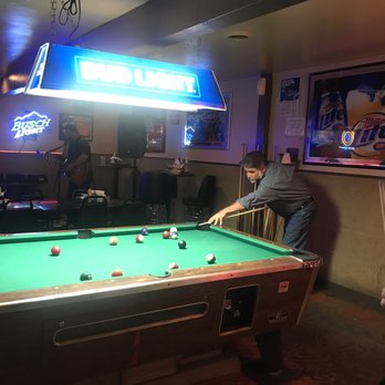 The Hideout - a man playing a game of pool - Bars Near Me - Warrenton, Missouri The Hideout - a man playing a game of pool - Bars Near Me - Warrenton, Missouri