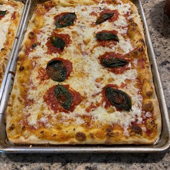 Bravo Pizza - two pans of pizza on a granite countertop - Pizza Near Me - Staten Island, New York Bravo Pizza - two pans of pizza on a granite countertop - Pizza Near Me - Staten Island, New York