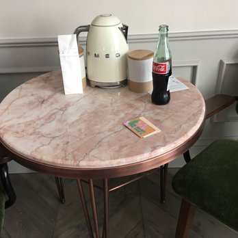 The Hoxton - Beautiful pink marble table for tow, with dark green velvet chairs. Supplied with coffee, tea, and water. - Hotels Near Me - Los Angeles, California The Hoxton - Beautiful pink marble table for tow, with dark green velvet chairs. Supplied with coffee, tea, and water. - Hotels Near Me - Los Angeles, California