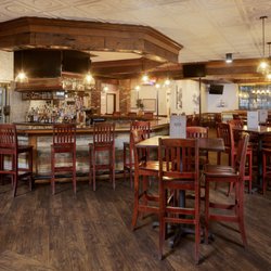 Don’s Seafood - Metairie - The bar at our Metairie location, featuring a full-service curved bar with a mosaic tile backsplash, comfortable barstool sea...