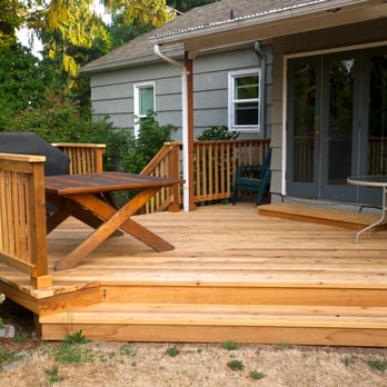 Moir Construction - a deck with a table and chairs - General Contractors Near Me - Eugene, Oregon Moir Construction - a deck with a table and chairs - General Contractors Near Me - Eugene, Oregon