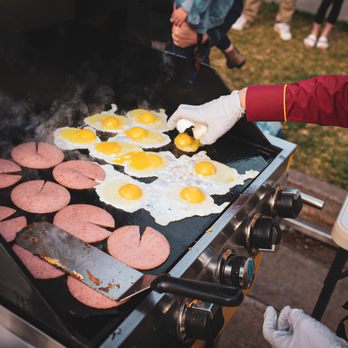 Jersey Cowboy - a man cooking eggs and sausages on a grill - Breakfast & Brunch Near Me - Fort Collins, Colorado
