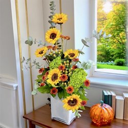 Eufloria Florist - Radiant Sol - sunflowers, green hydrangea, orange mums, hypericum berries and eucalyptus in a bright seasonal design.