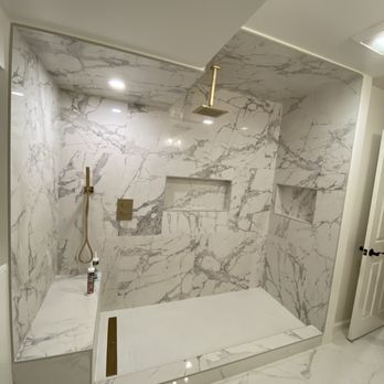 Elite Constructions - a bathroom with a marble shower - General Contractors Near Me Elite Constructions - a bathroom with a marble shower - General Contractors Near Me