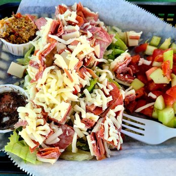 Bayou Bites - Muffalletta salad with a side of tomato/ cucumber salad - Cajun/Creole Near Me - Dunedin, Florida