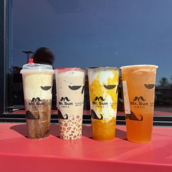 Mr Sun Tea - Left to right: Sweet cloud milk foam black tea, rainbow boba milk tea, mr sun mango, and mr sun green tea with non-alcoholic Heineken - Juice Bars & Smoothies Near Me - Fremont, California