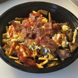 B'WICHED GOURMET SANDWICHES - Messy Hash Bowl: The Rancher! Homestyle potatoes browns with scrambled eggs, shredded cheddar, fried bacon, and a spicy ketchup drizzle!
