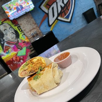 Sideline Bar & Grill - a burrito with a side of salsa - Bars Near Me - Norman, Oklahoma