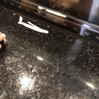 World Famous Boynton Beach - a person cleaning a counter top - New American Near Me - Boynton Beach, Florida World Famous Boynton Beach - a person cleaning a counter top - New American Near Me - Boynton Beach, Florida