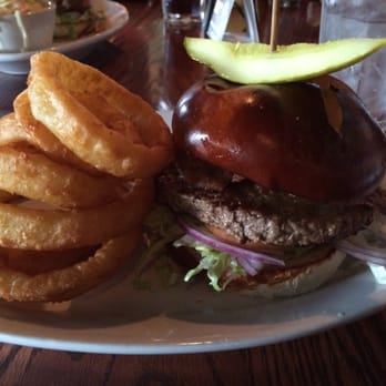 O'Hare's Pub - Bacon burger on a pretzel roll with onion rings - Sports Bars Near Me - Bartlett, Illinois O'Hare's Pub - Bacon burger on a pretzel roll with onion rings - Sports Bars Near Me - Bartlett, Illinois