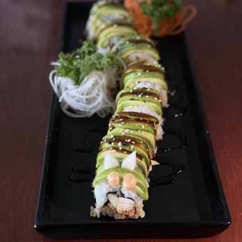 Zomos - a sushi roll on a black plate - Sushi Bars Near Me - Sunnyside, Washington Zomos - a sushi roll on a black plate - Sushi Bars Near Me - Sunnyside, Washington