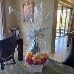 Beautiful gift basket! Champagne, flutes, and tropical flowers.