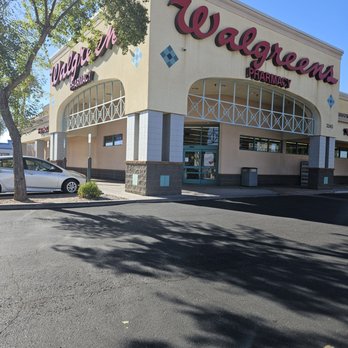 Walgreens - A Walgreens pharmacy storefront with parking spaces, trees, and a clear blue sky, showing the store's signage and entrance. - Drugstores Near Me - Gilbert, Arizona